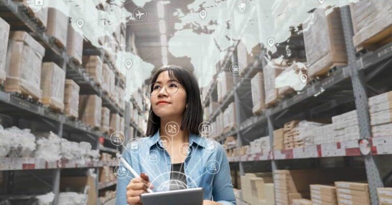 woman looking at inventory in warehouse using smart tablet in management technology, interconnected industry,